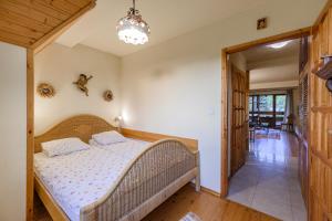 a bedroom with a bed and a hallway at Apartament W Dolinie Słońca & SPA in Kościelisko +41 photos