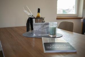 a bottle of wine and a glass on a table at Best Stay Apartment Rhönblick Dietershausen in Künzell +3 photos