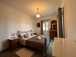 a bedroom with a bed with a teddy bear on it at VISTA MARE Kythera House in Agia Pelagia