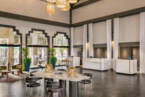 a lobby with a table and chairs and windows at Hilton Scottsdale Resort & Villas in Scottsdale +76 photos