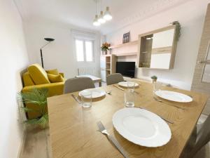 a dining room table with two white plates on it at Lacasitadevaleria in Santander +23 photos