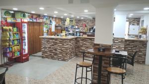 a restaurant with a counter and two tables and chairs at albergue bar villamayor in Villamayor del Río