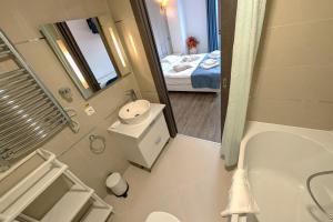 a bathroom with a tub and a sink and a mirror at Travel Concept - Silver Mountain in Poiana Brasov +16 photos