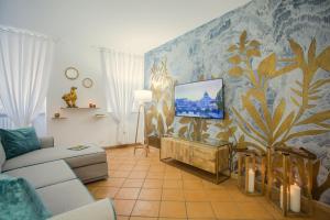 a living room with a couch and a tv on a wall at Domus Regola Luxury Apartment in Rome +37 photos