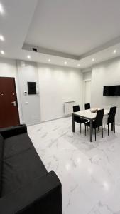 a living room with a table and chairs and a couch at Karma apartment in Catania +14 photos