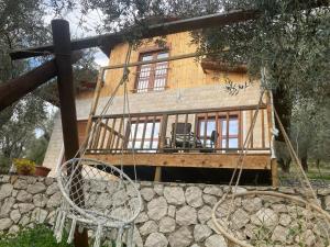 a house with a swing in front of it at Cottage Four Olives in Ulcinj