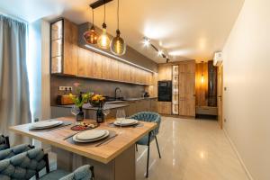 a kitchen and dining room with a table and chairs at Kabakum Avangard in Golden Sands
