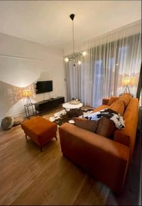 a living room with a couch and a tv at Royal apartman Banja Luka in Banja Luka
