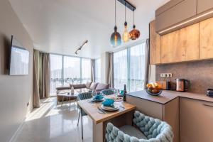 a kitchen and living room with a table and chairs at Kabakum Avangard in Golden Sands +22 photos