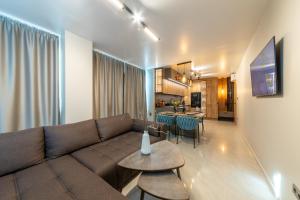 a living room with a couch and a table and a kitchen at Kabakum Avangard in Golden Sands