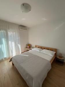 Postel nebo postele na pokoji v ubytování Apartments Zulim