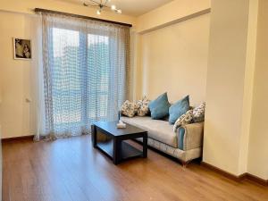 a living room with a couch and a table at Prime apartment in Buzand 17 with beautiful terrace in Yerevan