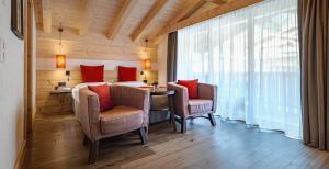 Rúm í herbergi á Hotel Spitzhorn Superieur