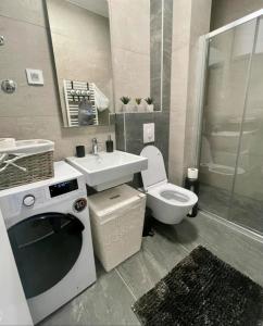 a bathroom with a sink and a toilet and a shower at Royal apartman Banja Luka in Banja Luka