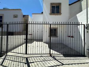 an iron gate in front of a building at La Casa de Noches de Palomitas in San Juan de los Lagos