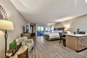 a hotel room with a bed and a living room at Lakeland Village 107 Laugh Love Updated Studio in South Lake Tahoe +27 photos