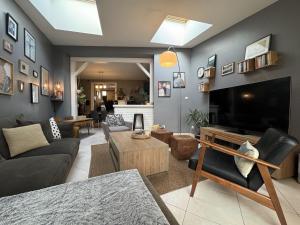 a living room with a large flat screen tv at The Light Downtown - 9 pers - 24h du Mans - Rêve au Mans in Le Mans