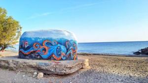 a cake with an octopus painted on it on the beach at Niki's Dream House in Ierapetra