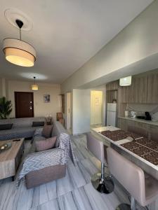 a large living room with a couch and a kitchen at Hanna's Apartment in Chios