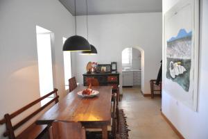 a dining room with a wooden table and chairs at Zeus House by GHH in Hydra