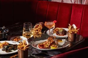 a table with plates of food and glasses of wine at Hilton Toronto in Toronto +82 photos