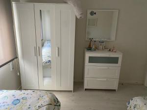 1 dormitorio con tocador blanco y espejo en Panxon Madorra Mar, en Panjón