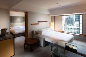 Postel nebo postele na pokoji v ubytování Hilton Tokyo Hotel
