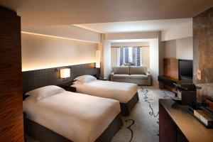 Postel nebo postele na pokoji v ubytování Hilton Tokyo Hotel