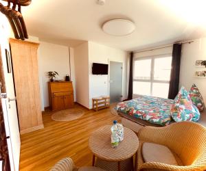 a living room with a couch and a bed at MiNe Hotel in Weilerswist