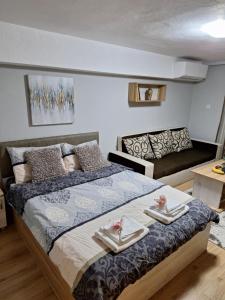 a bedroom with a bed with two pairs of shoes on it at Apart 8 in Sandanski +17 photos