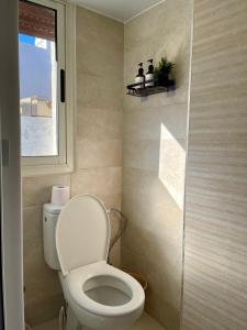 a small bathroom with a toilet and a window at Cozy nest bedroom - family only in Tangier