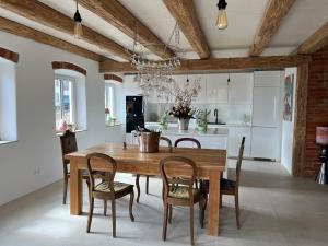 a dining room with a wooden table and chairs at Landhaus 1868 in Villenbach