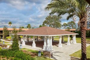 奥兰多DoubleTree by Hilton Hotel Orlando at SeaWorld的有两张长椅和一棵棕榈树的凉亭 更多37张照片