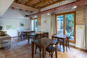 a dining room with wooden tables and chairs at Hotel La Freixera in Solsona
