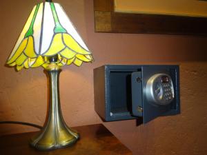 a lamp and a lightswitch next to a lampccess at Sissi Haz Hotel in Buenos Aires