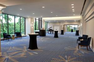 a lobby with chairs and tables and windows at Hilton Mississauga/Meadowvale in Mississauga +79 photos