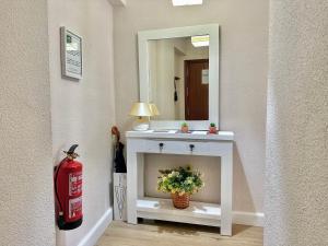 a white vanity with a mirror and a fire hydrant at Apartamento Alcázar San Basilio in Córdoba