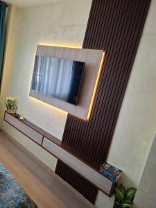 a living room with a tv on a wall at The View in Sandanski