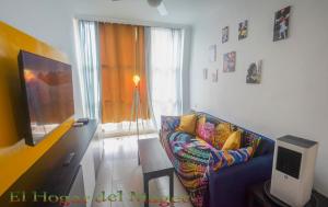 a living room with a couch and a television at EL HOGAR DEL MAGEC in Las Palmas de Gran Canaria