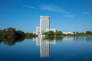 a large building sitting on top of a large lake at Hilton Orlando Buena Vista Palace - Disney Springs Area in Orlando