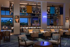 a lobby of a hotel with tables and chairs at Hilton Orlando Buena Vista Palace - Disney Springs Area in Orlando