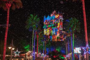 a tall building is lit up with christmas lights at Hilton Orlando Buena Vista Palace - Disney Springs Area in Orlando