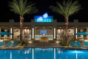 a resort with a pool and palm trees and a television at Hilton Orlando Buena Vista Palace - Disney Springs Area in Orlando