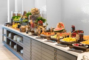 a buffet line with many different types of fruits and vegetables at Hilton Orlando Buena Vista Palace - Disney Springs Area in Orlando