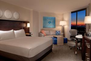 a hotel room with a bed and a living room at Hilton Orlando Buena Vista Palace - Disney Springs Area in Orlando