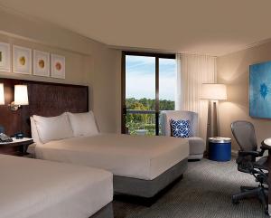 a hotel room with two beds and a window at Hilton Orlando Buena Vista Palace - Disney Springs Area in Orlando