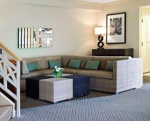 a living room with a couch and a coffee table at Hilton Orlando Buena Vista Palace - Disney Springs Area in Orlando