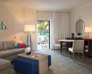 a living room with a couch and a table at Hilton Orlando Buena Vista Palace - Disney Springs Area in Orlando
