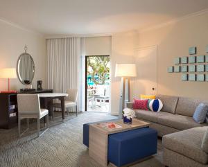 a living room with a couch and a table at Hilton Orlando Buena Vista Palace - Disney Springs Area in Orlando