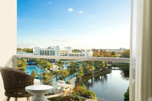 a balcony with a view of a river and buildings at Hilton Orlando Buena Vista Palace - Disney Springs Area in Orlando